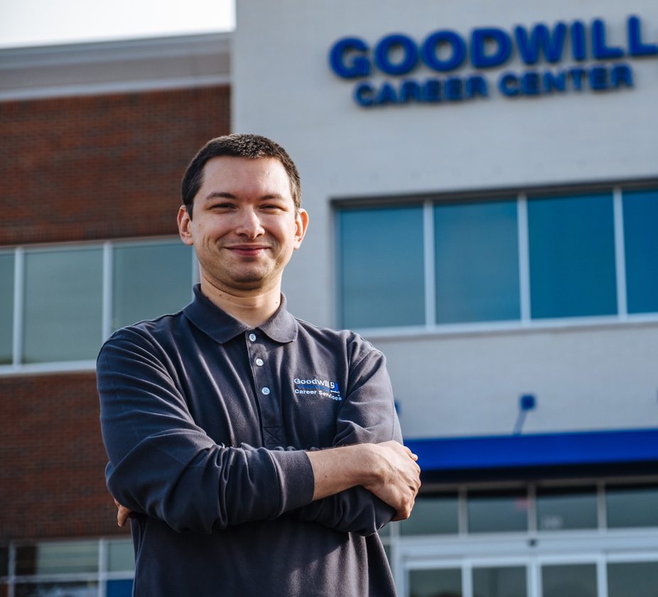 Goodwill employee standing in front of a Goodwill store