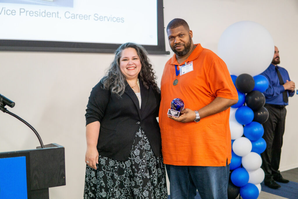 male and female holding award