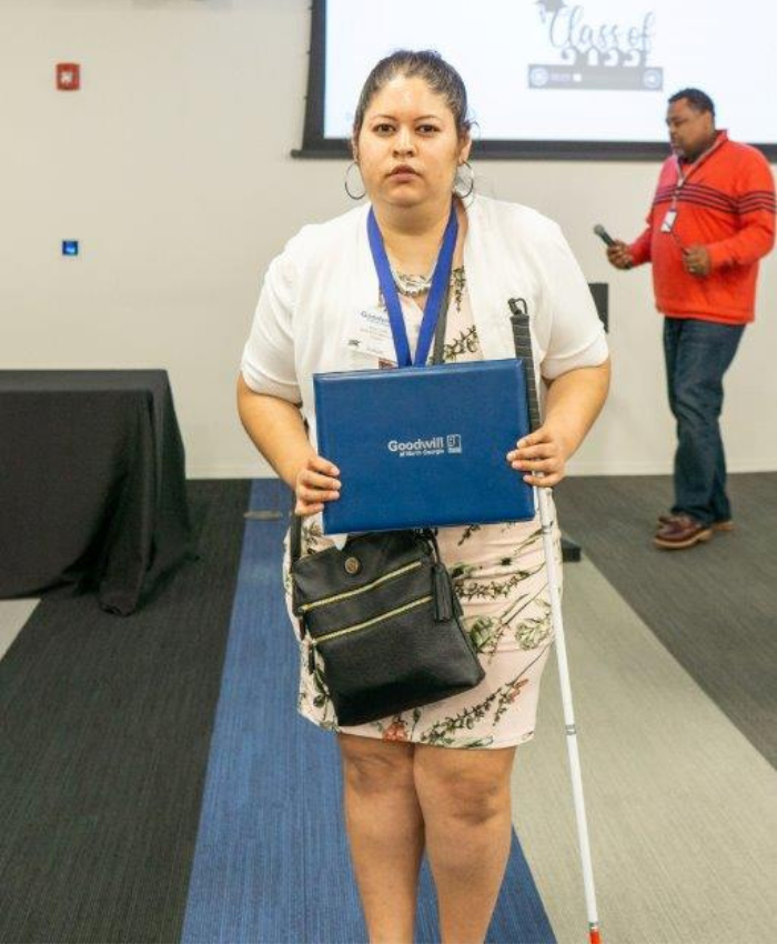 Visually impaired woman holding award