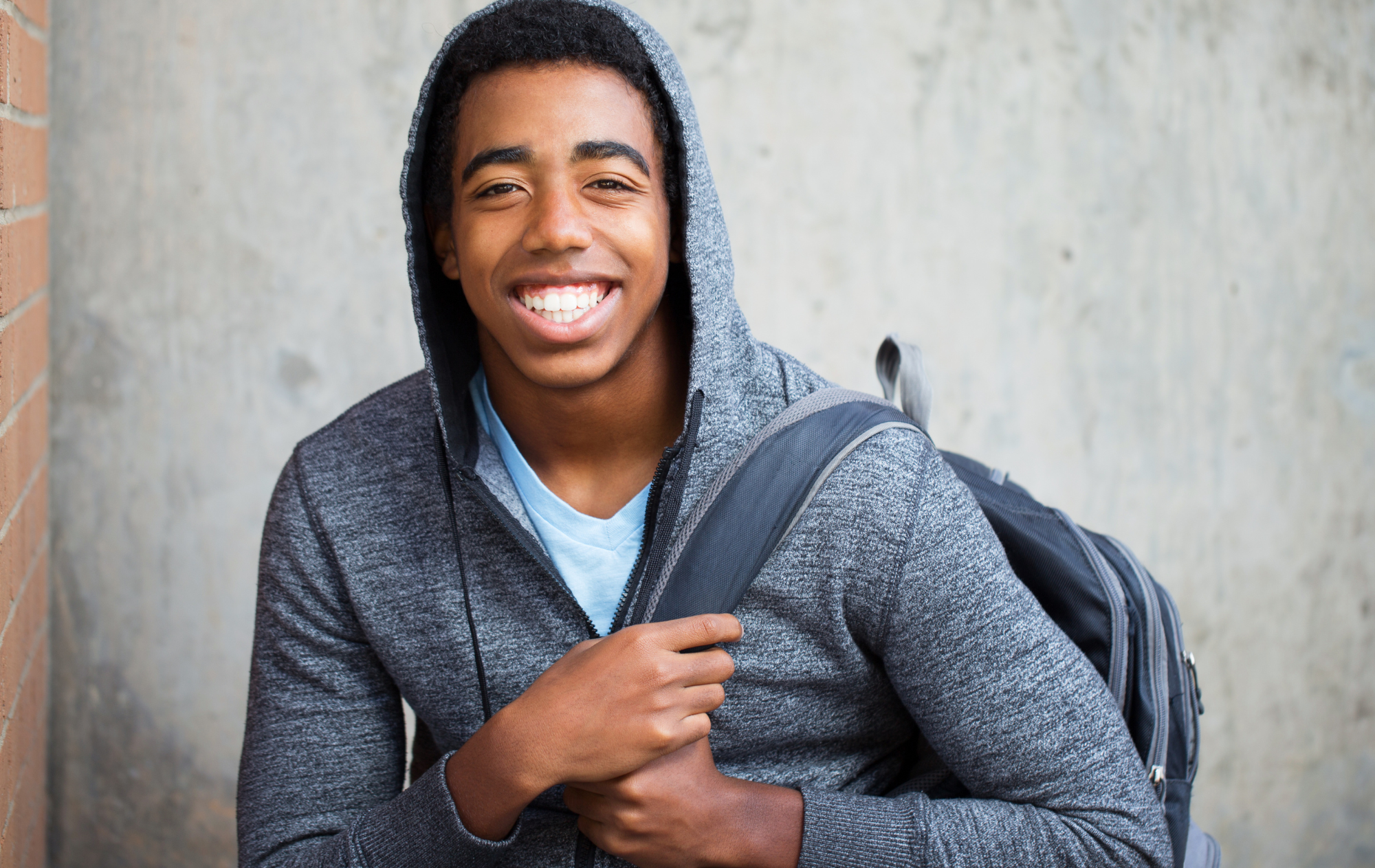 Teen with hoodie and backpack